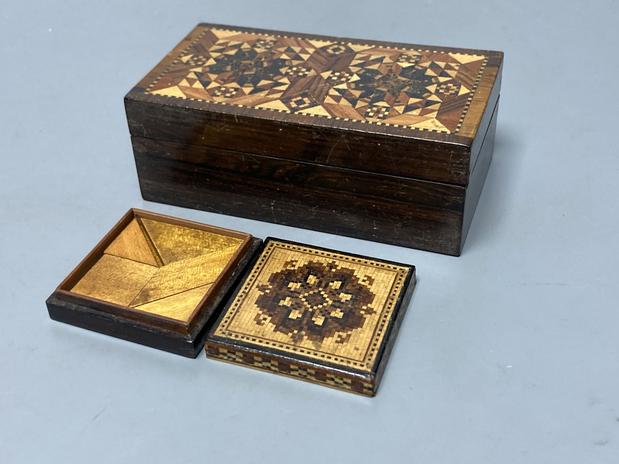 A Tunbridge ware mosaic lidded tangram puzzle and a half square mosaic box with inner tray, mid 19th century, 5cm and 11.6cm (2)